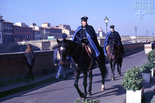 Vigili (600Wx400H) - Two 'Vigili' [Police agents of the Municipality of Florence] riding along the River Arno.(Photo by Marco De La Pierre) 